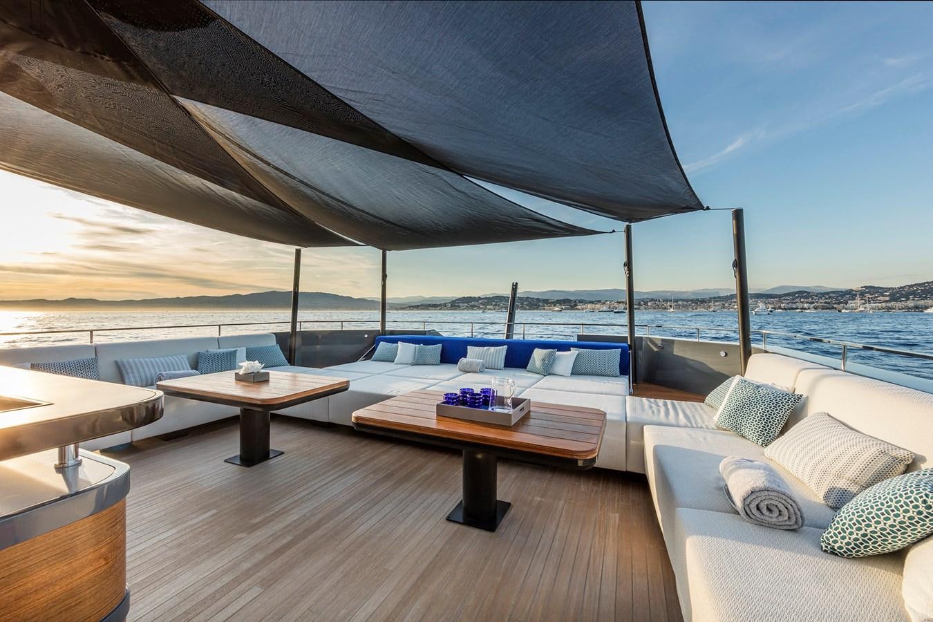 a deck with a table and chairs aboard SEA CORAL II Yacht for Sale