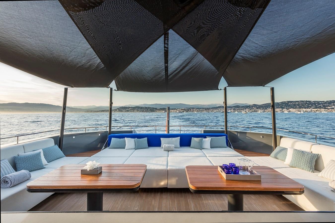 a deck with a table and chairs on it aboard SEA CORAL II Yacht for Sale