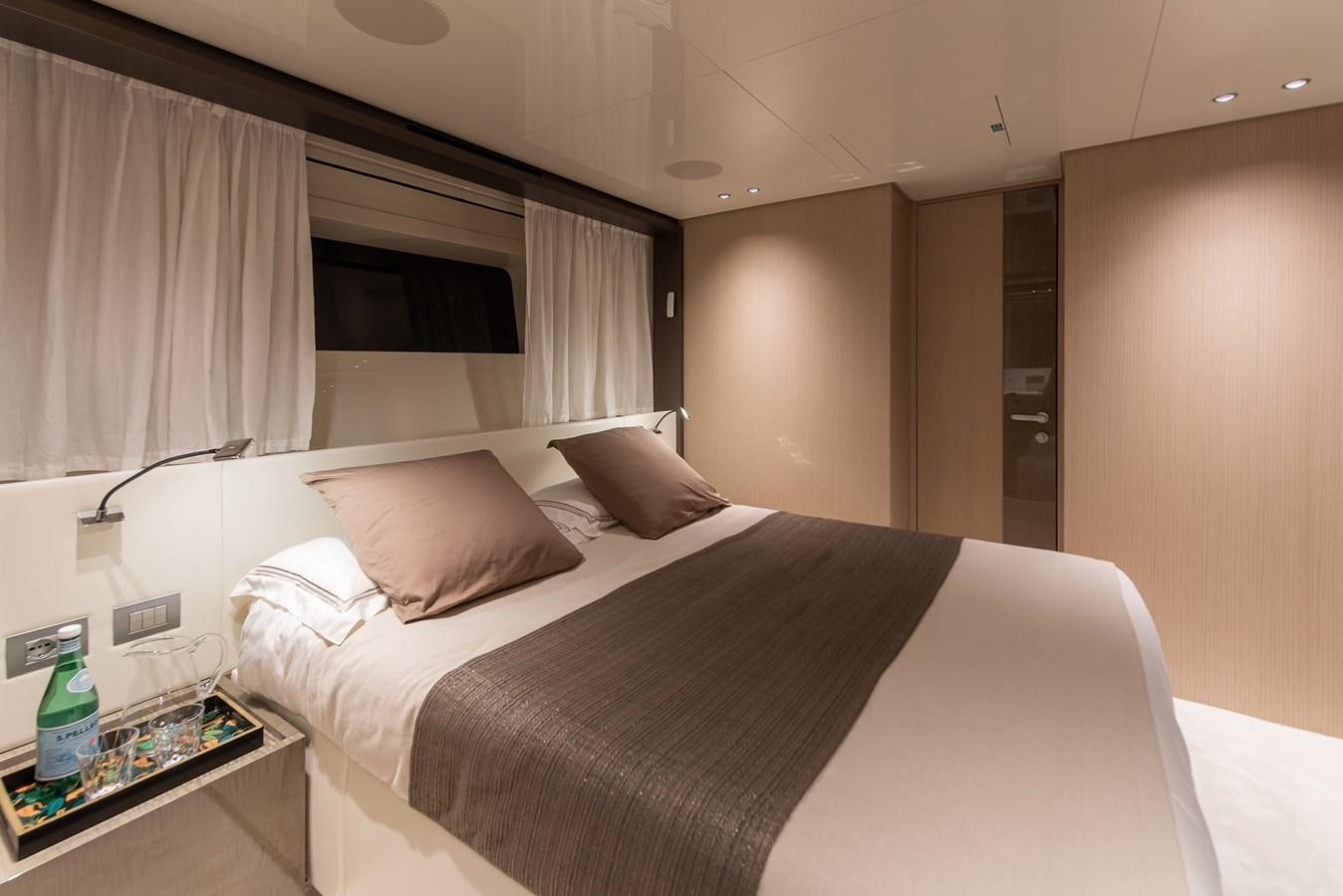 a bed with a white sheet and pillows aboard STONE HILLS Yacht for Sale