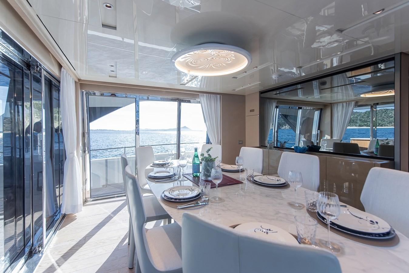 a dining room with a large window aboard STONE HILLS Yacht for Sale