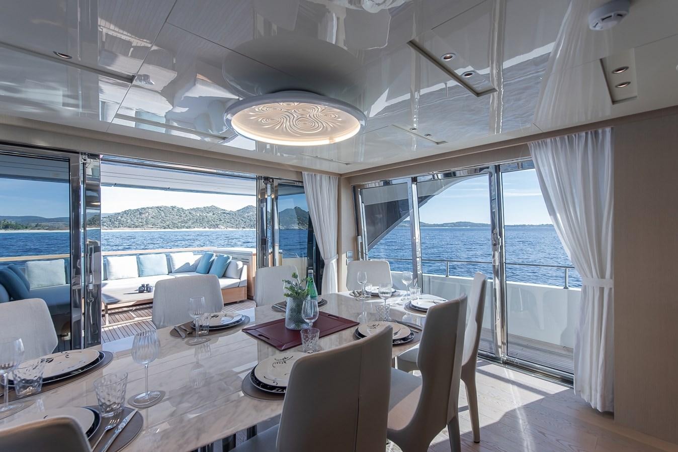 a dining room with a large window aboard STONE HILLS Yacht for Sale