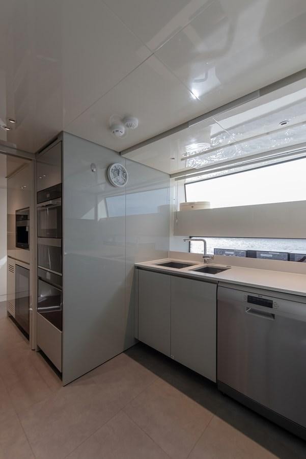 a kitchen with a sink and a refrigerator aboard STONE HILLS Yacht for Sale