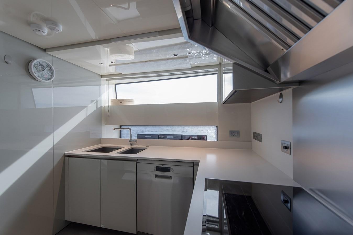 a kitchen with white cabinets aboard STONE HILLS Yacht for Sale
