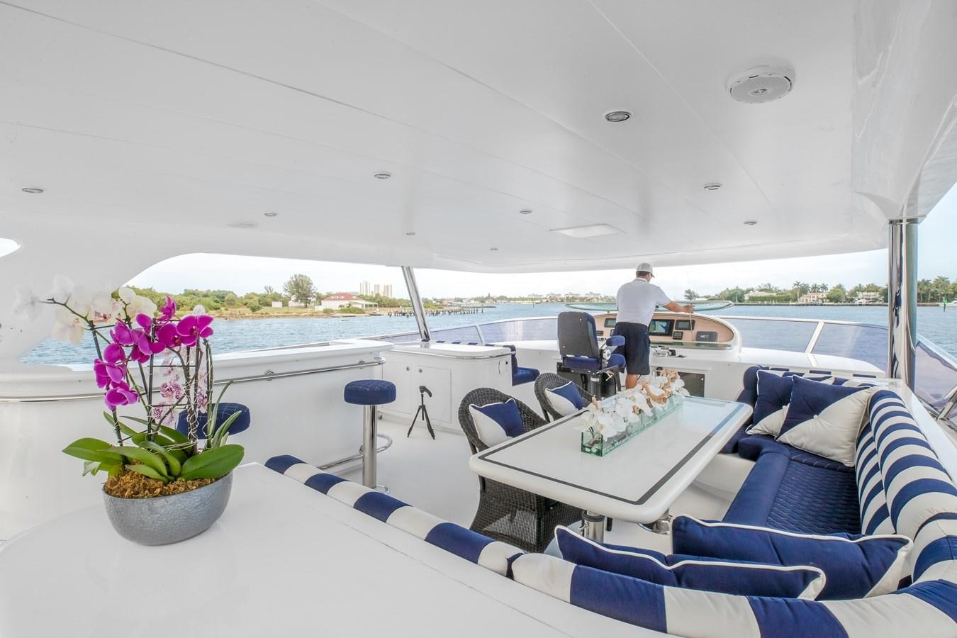 a boat with a table and chairs aboard BAD DADDY Yacht for Sale