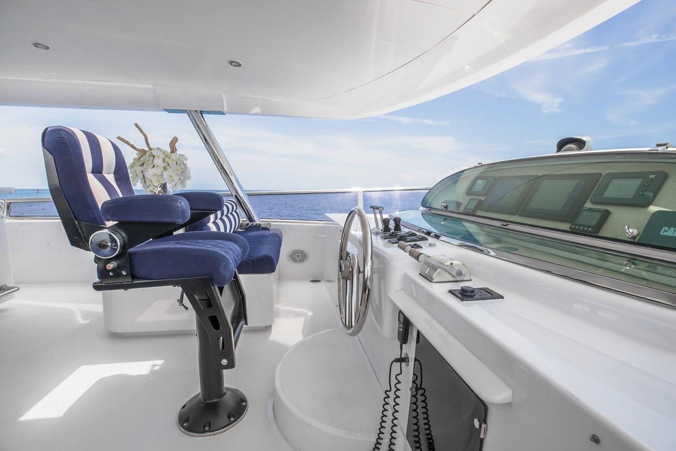a boat with a blue seat and a green car on the deck aboard BAD DADDY Yacht for Sale