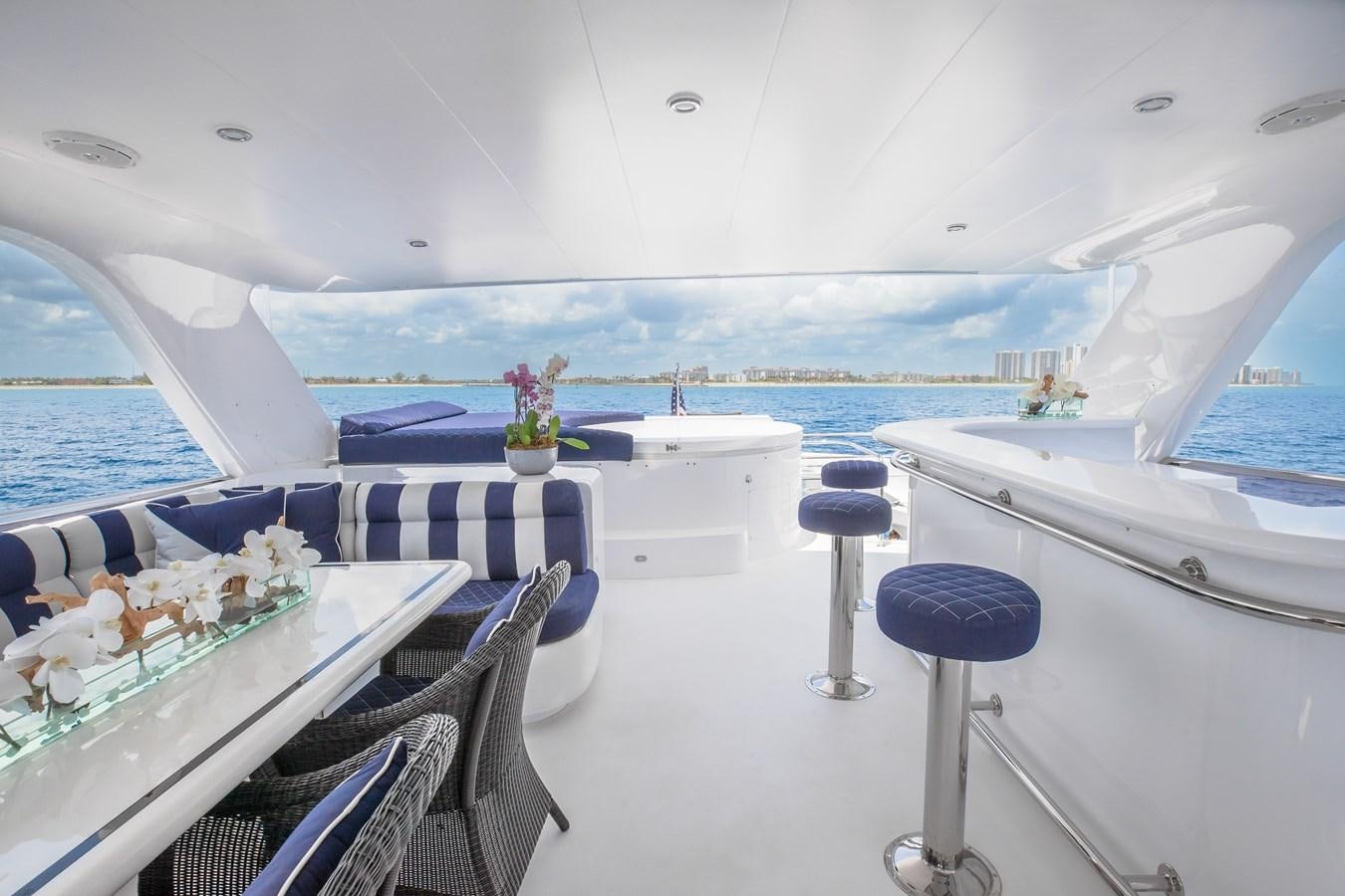 a room with a table chairs and a view of the ocean aboard BAD DADDY Yacht for Sale