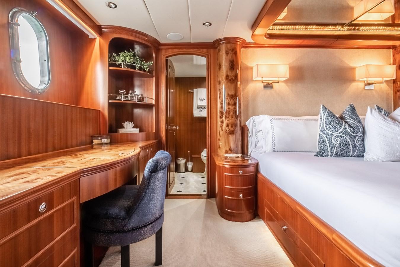 a bedroom with a bed and a desk aboard BAD DADDY Yacht for Sale