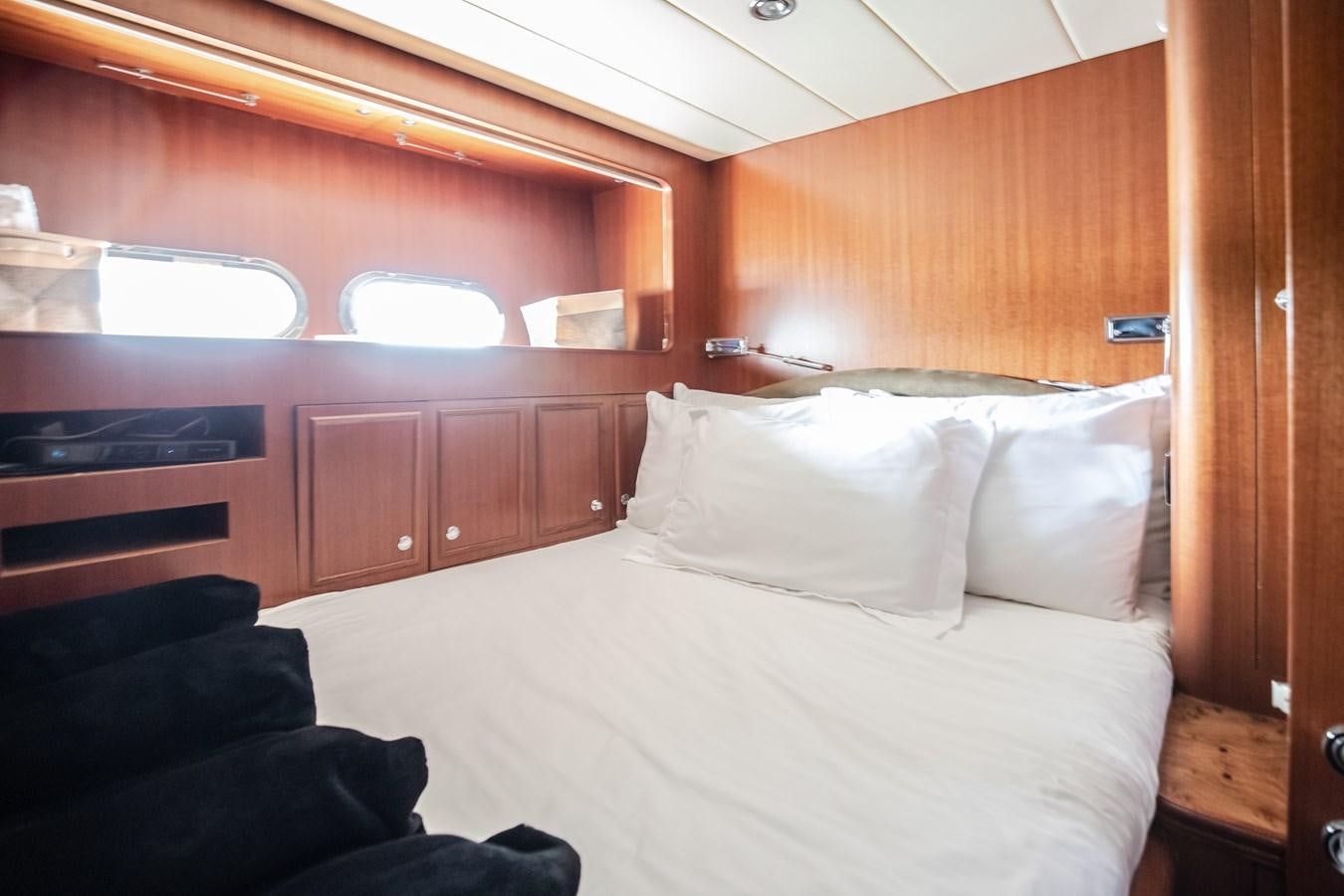 a bed with white sheets aboard BAD DADDY Yacht for Sale