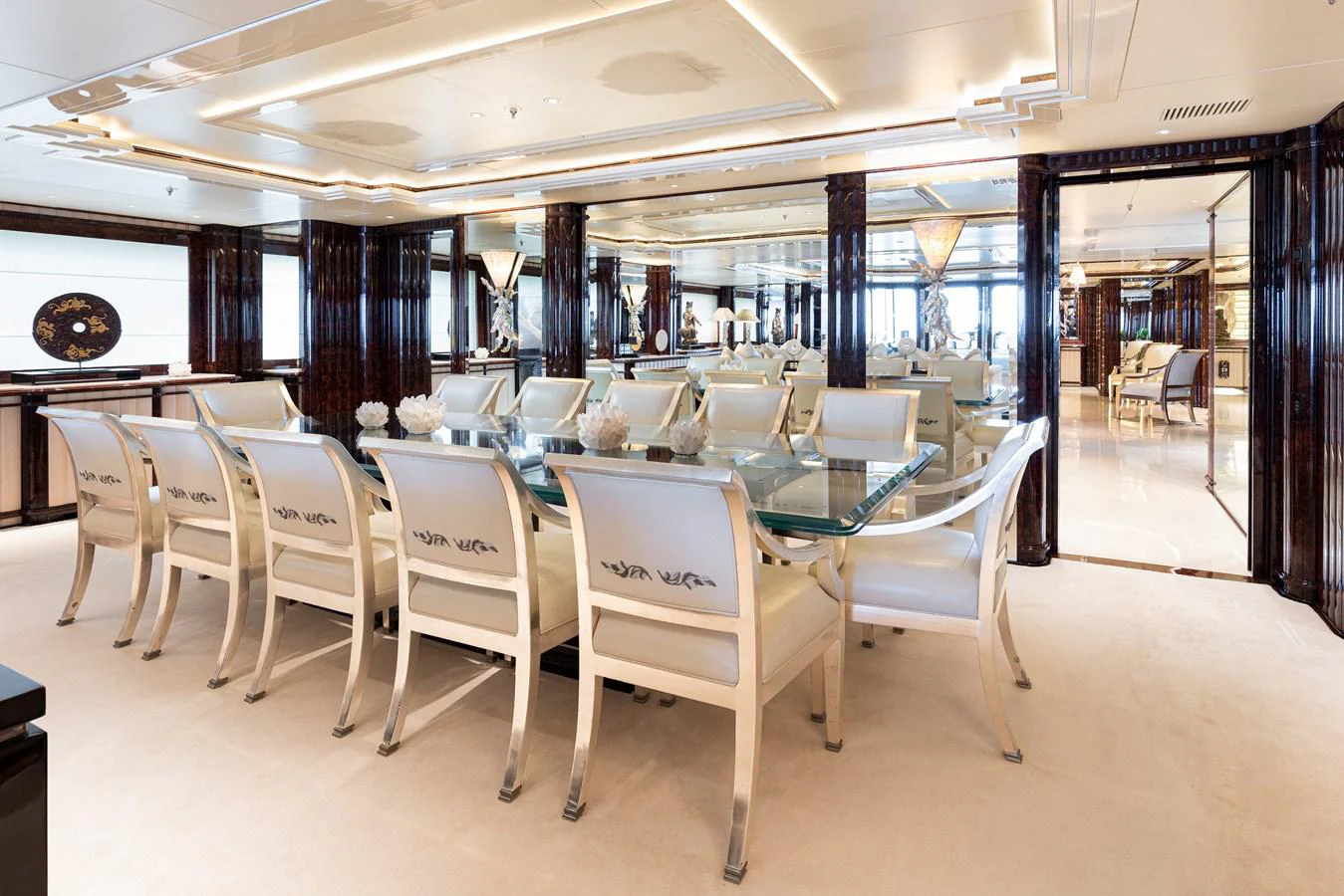 a room with tables and chairs aboard LIONESS V Yacht for Sale