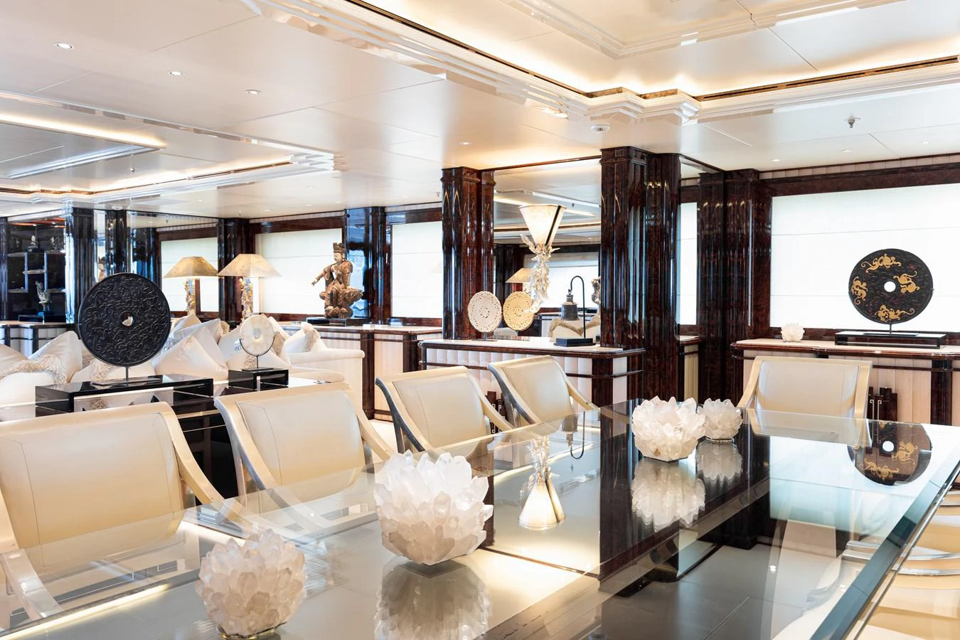 a room with a large display of vases and chairs aboard LIONESS V Yacht for Sale