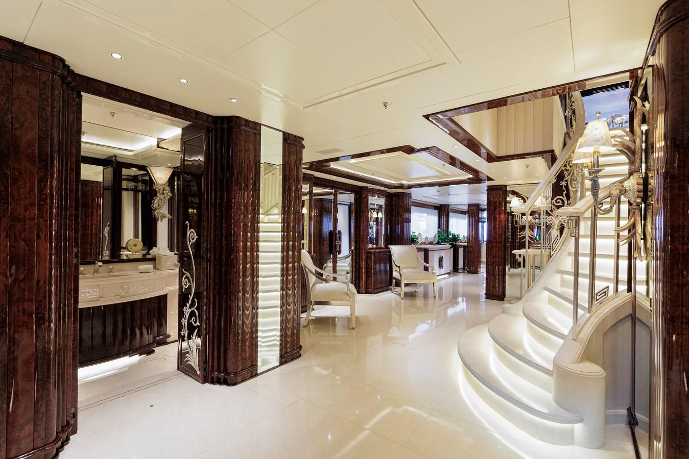 a hallway with a staircase and chairs aboard LIONESS V Yacht for Sale
