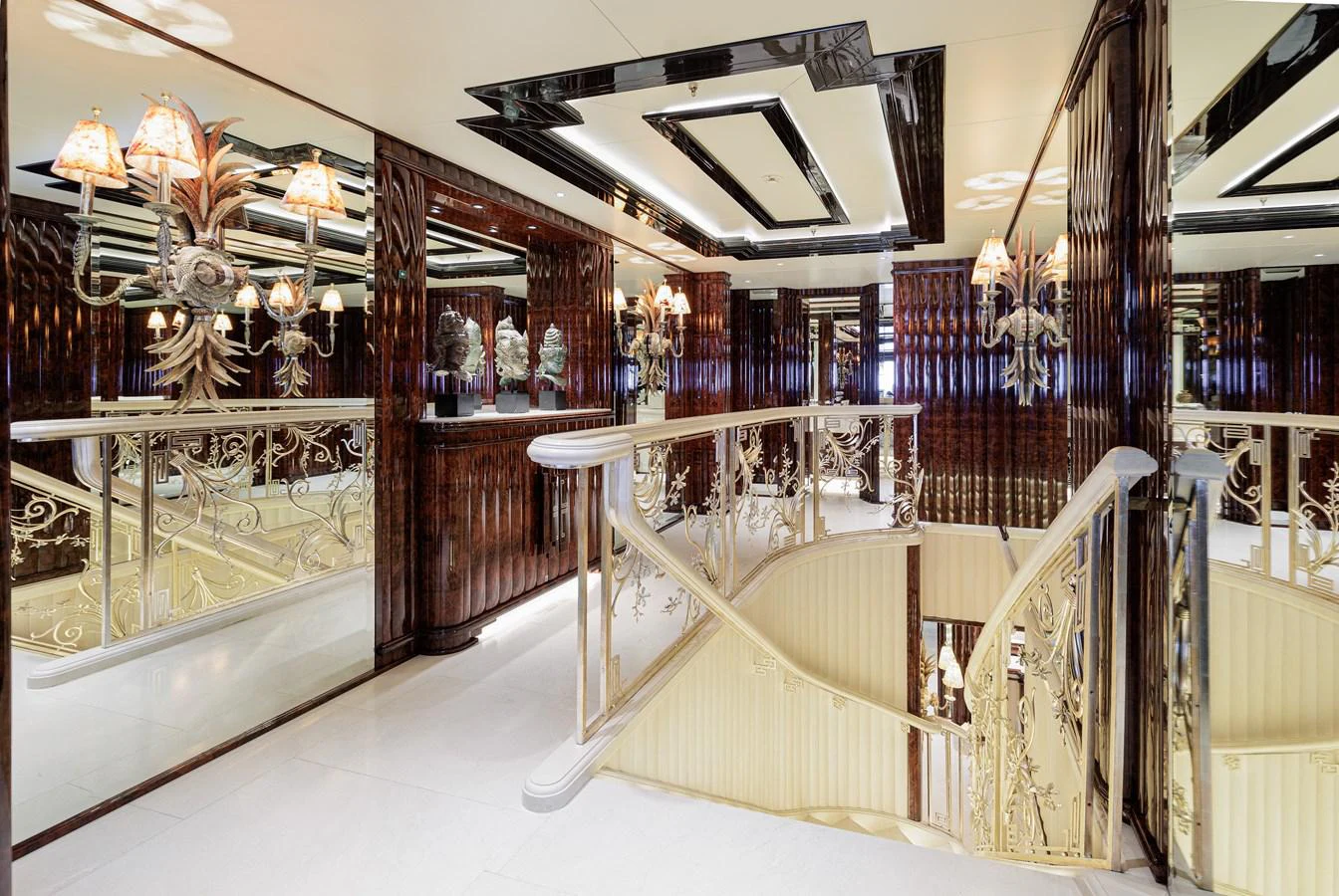 a room with a white railing and chandeliers aboard LIONESS V Yacht for Sale