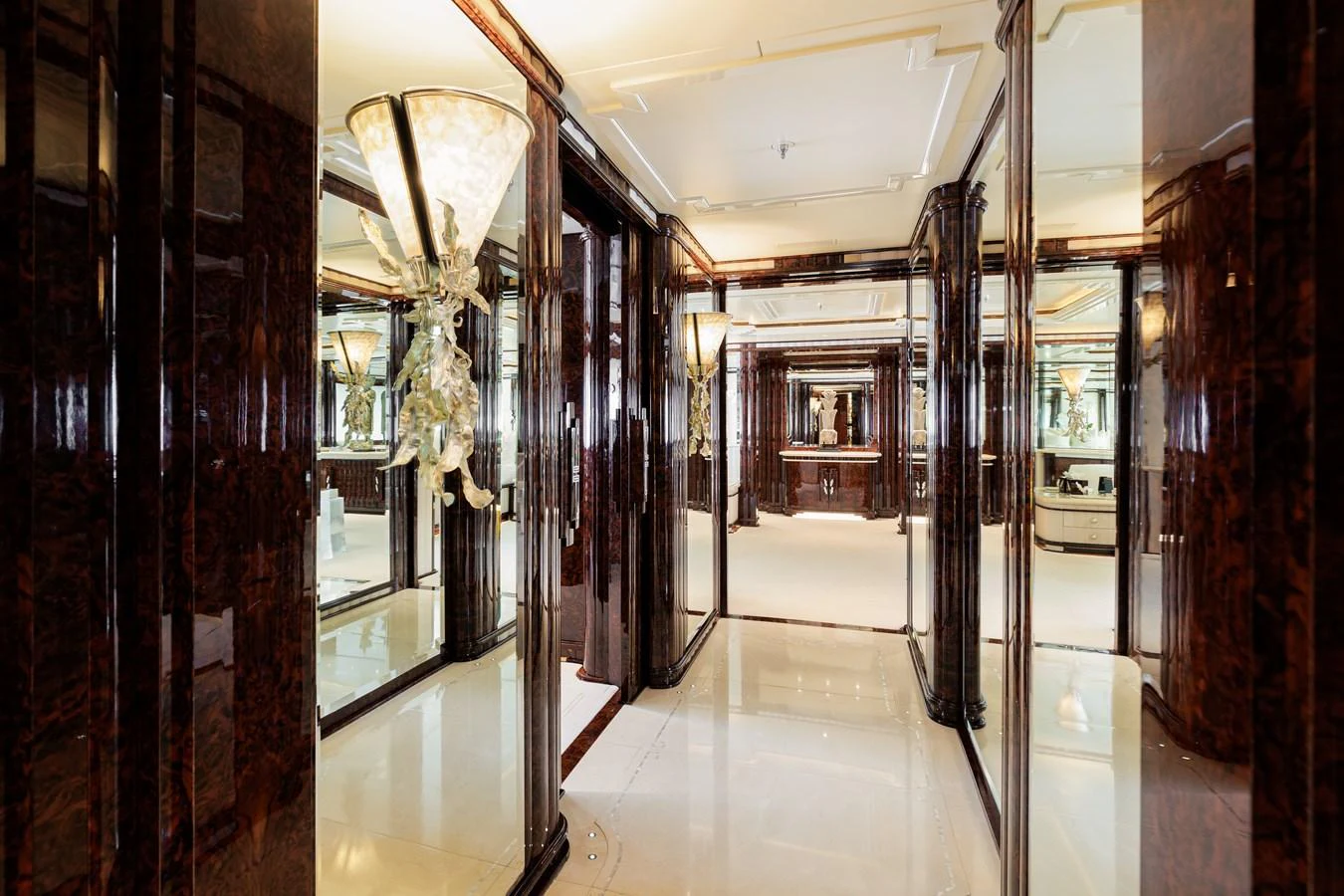a hallway with glass doors aboard LIONESS V Yacht for Sale