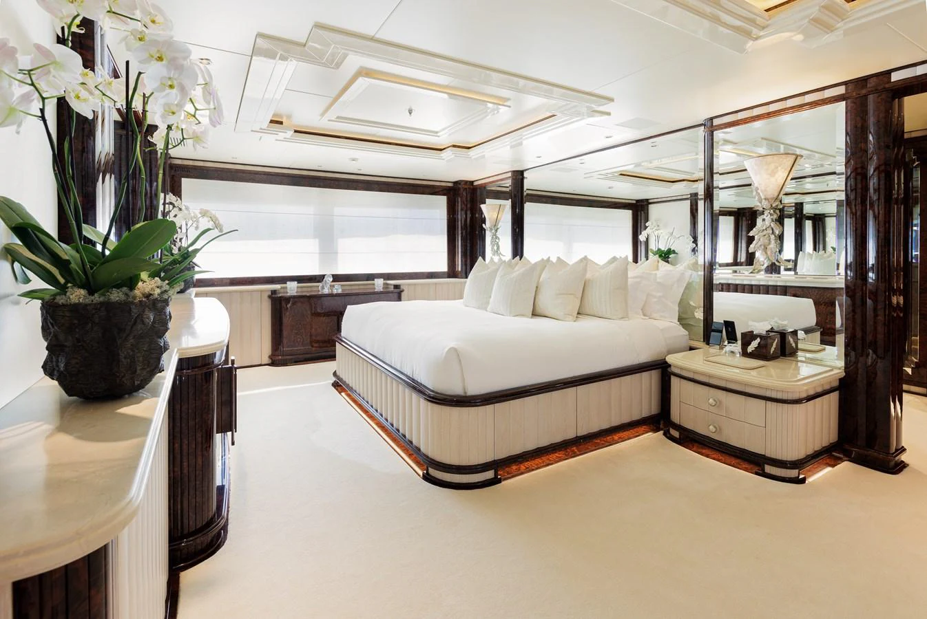 a bedroom with a bed and a plant aboard LIONESS V Yacht for Sale