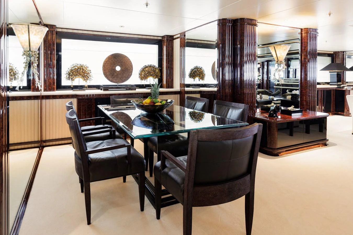 a room with a table and chairs aboard LIONESS V Yacht for Sale