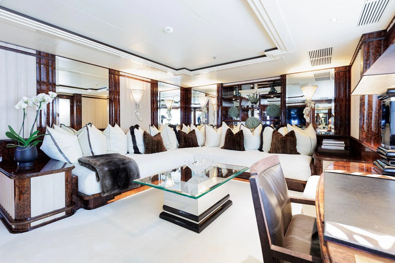 a living room with a large mirror aboard LIONESS V Yacht for Sale