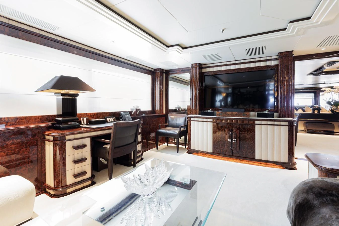 a room with a table chairs and a television aboard LIONESS V Yacht for Sale