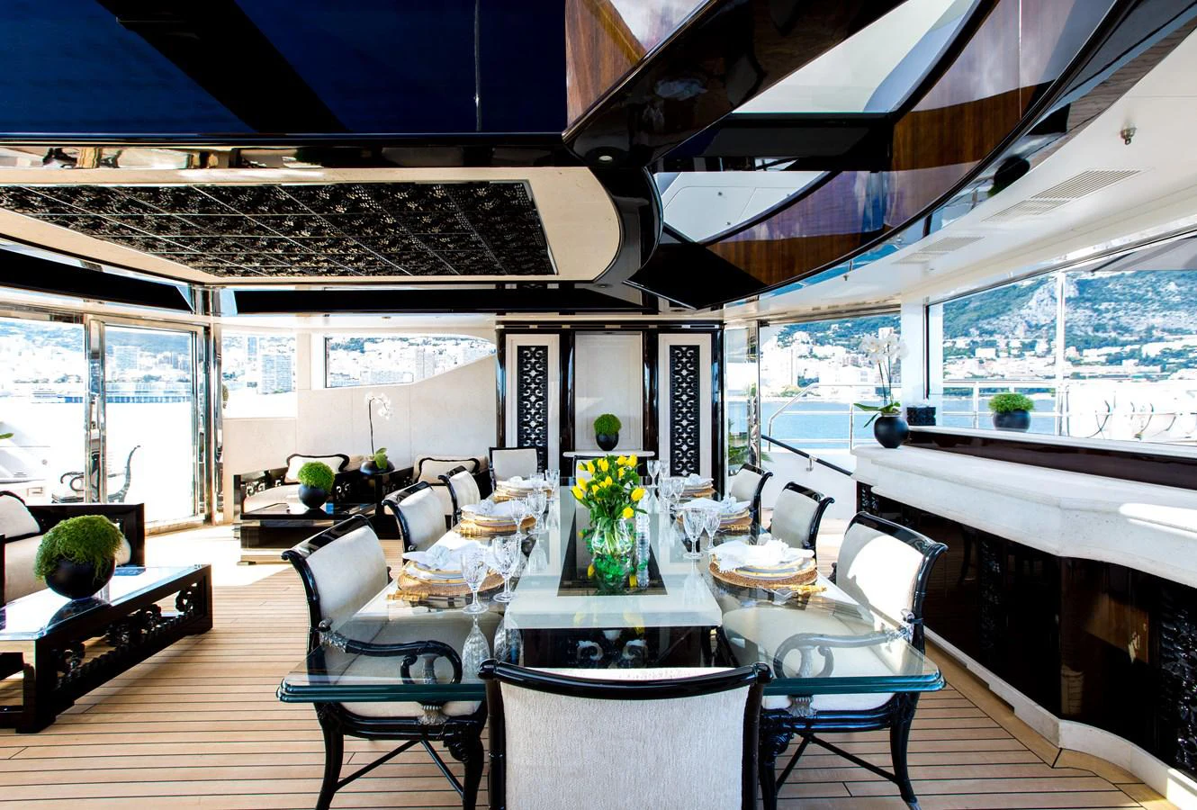 a room with tables and chairs aboard LIONESS V Yacht for Sale