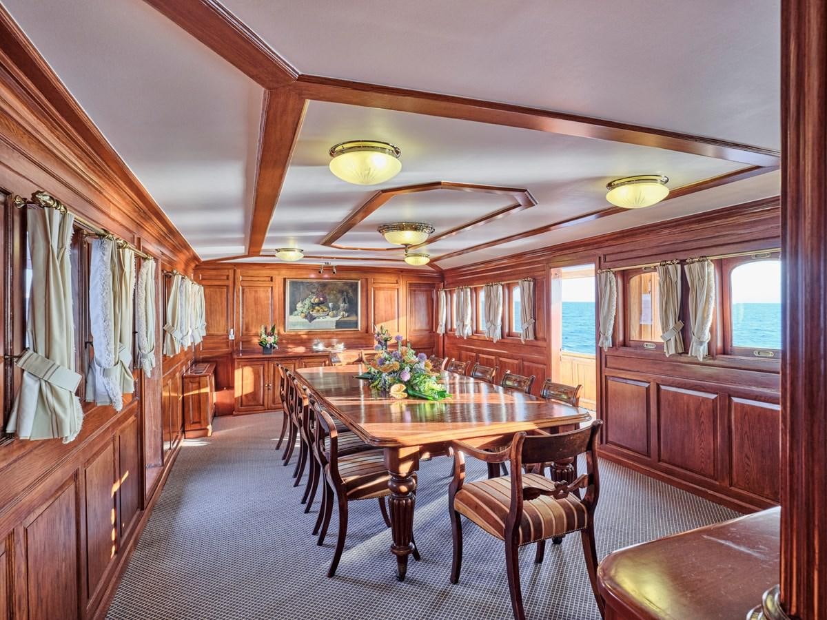 a dining room with wood cabinets aboard MADIZ Yacht for Sale