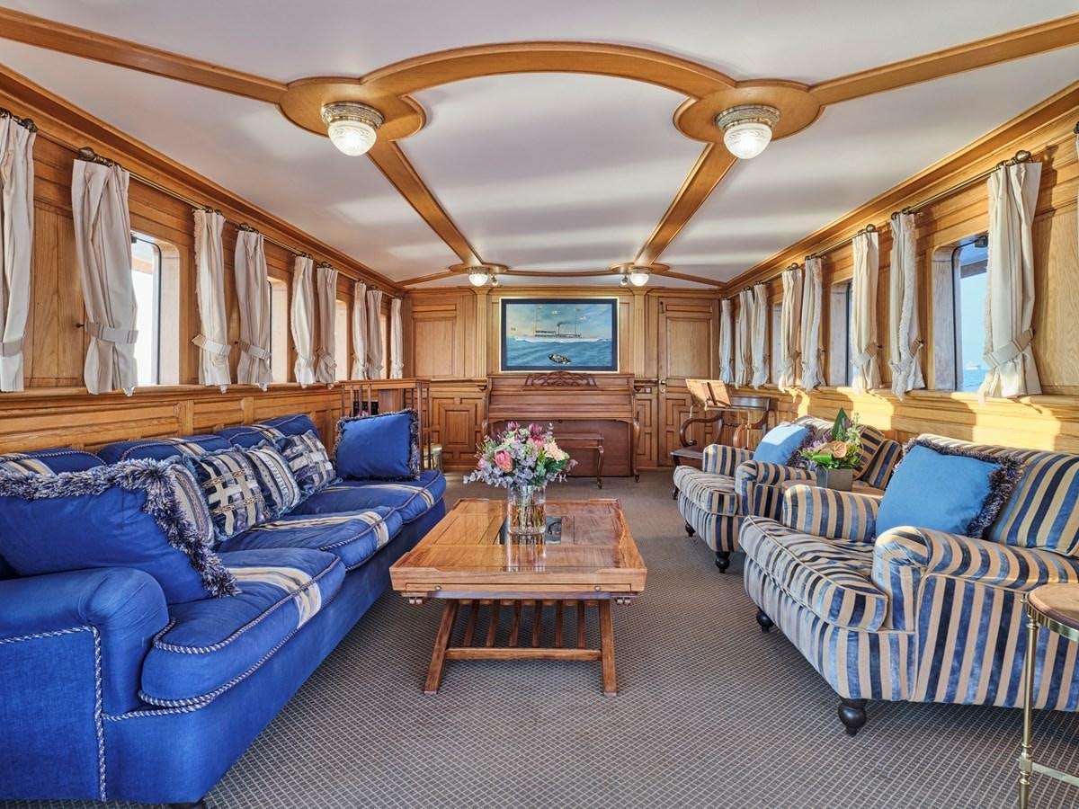 a living room with a couch and a table aboard MADIZ Yacht for Sale