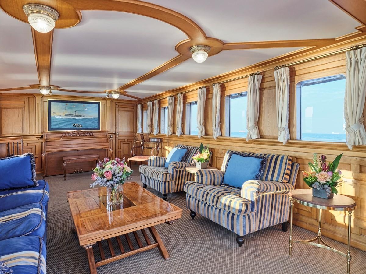 a living room with a couch and a coffee table aboard MADIZ Yacht for Sale