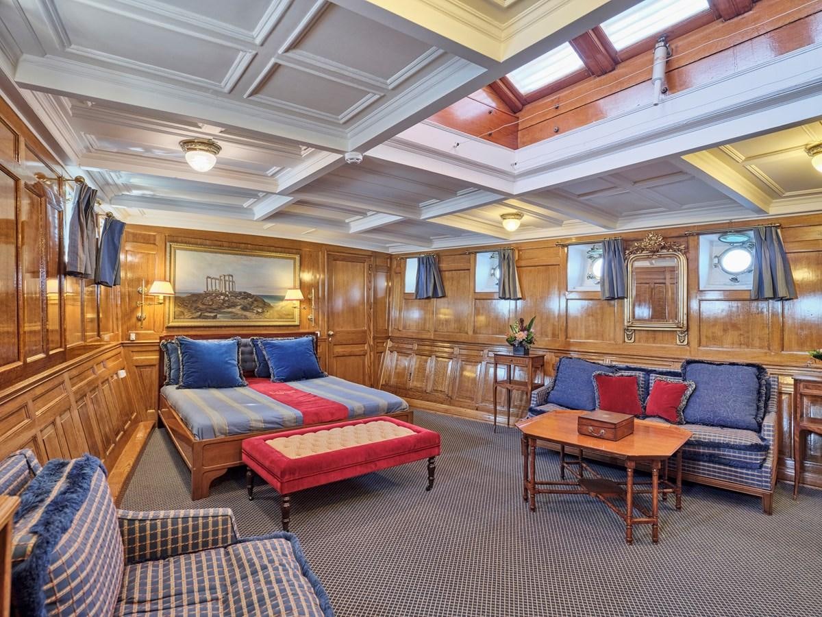a living room with a couch and a table aboard MADIZ Yacht for Sale