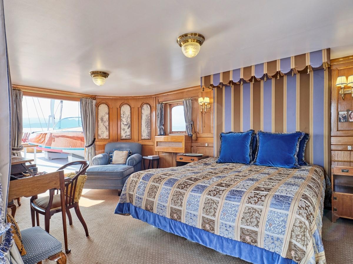 a bedroom with a bed and a couch aboard MADIZ Yacht for Sale