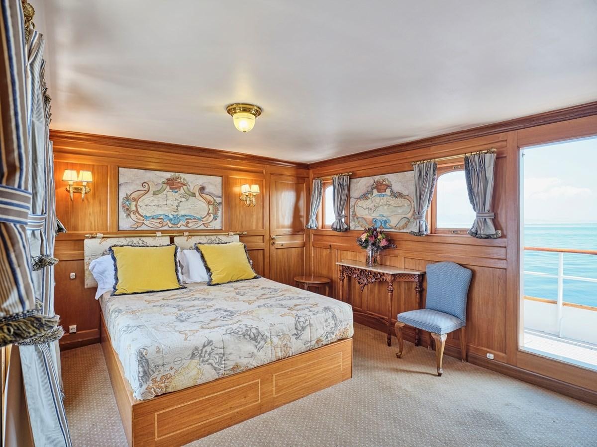 a bedroom with a bed and a desk aboard MADIZ Yacht for Sale