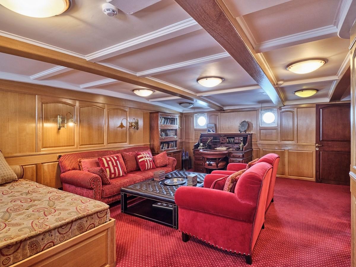 a living room with a red rug aboard MADIZ Yacht for Sale