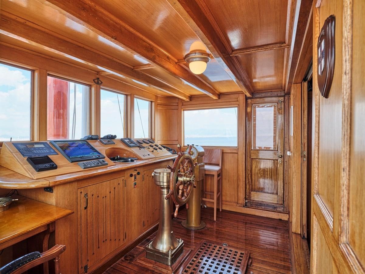a wooden cabin with a desk and computer aboard MADIZ Yacht for Sale