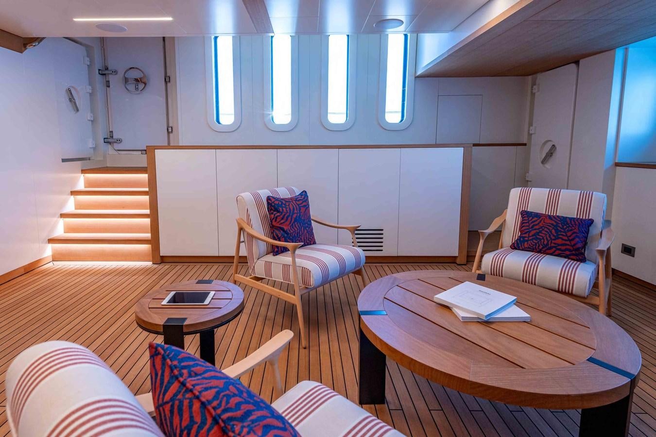 a room with a table chairs and a couch aboard MISS CANDY Yacht for Sale