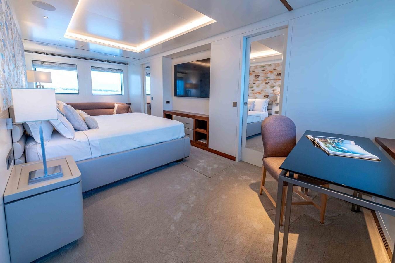 a bedroom with a bed and a desk aboard MISS CANDY Yacht for Sale