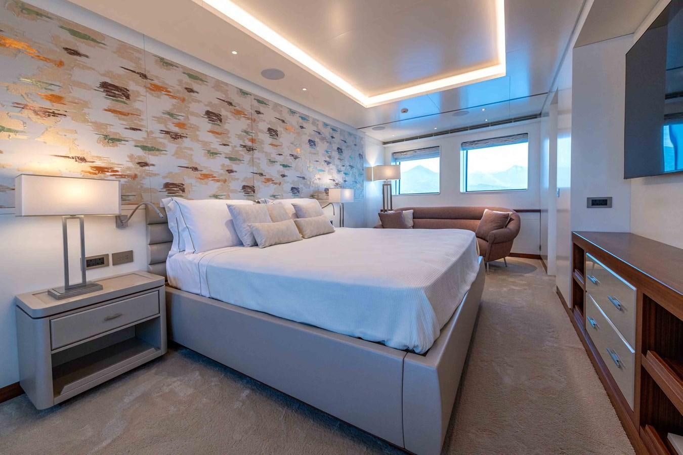 a bedroom with a bed and a desk aboard MISS CANDY Yacht for Sale