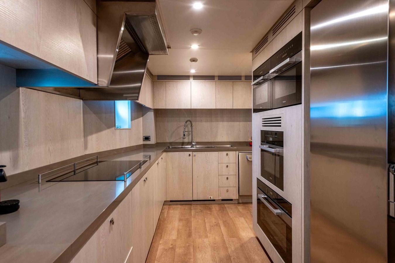 a kitchen with white cabinets aboard MISS CANDY Yacht for Sale