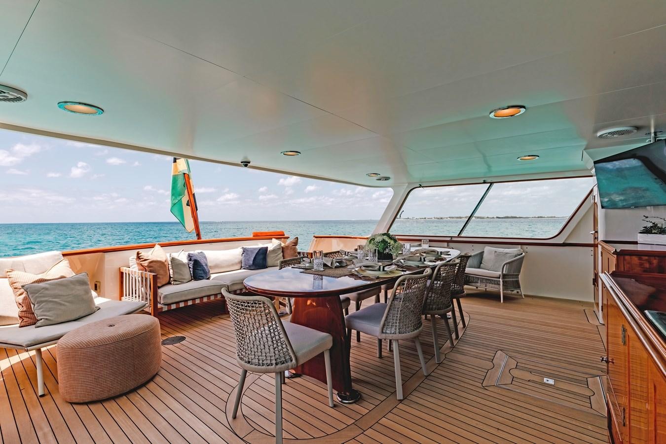 a deck with a table and chairs aboard CALYPSO Yacht for Sale