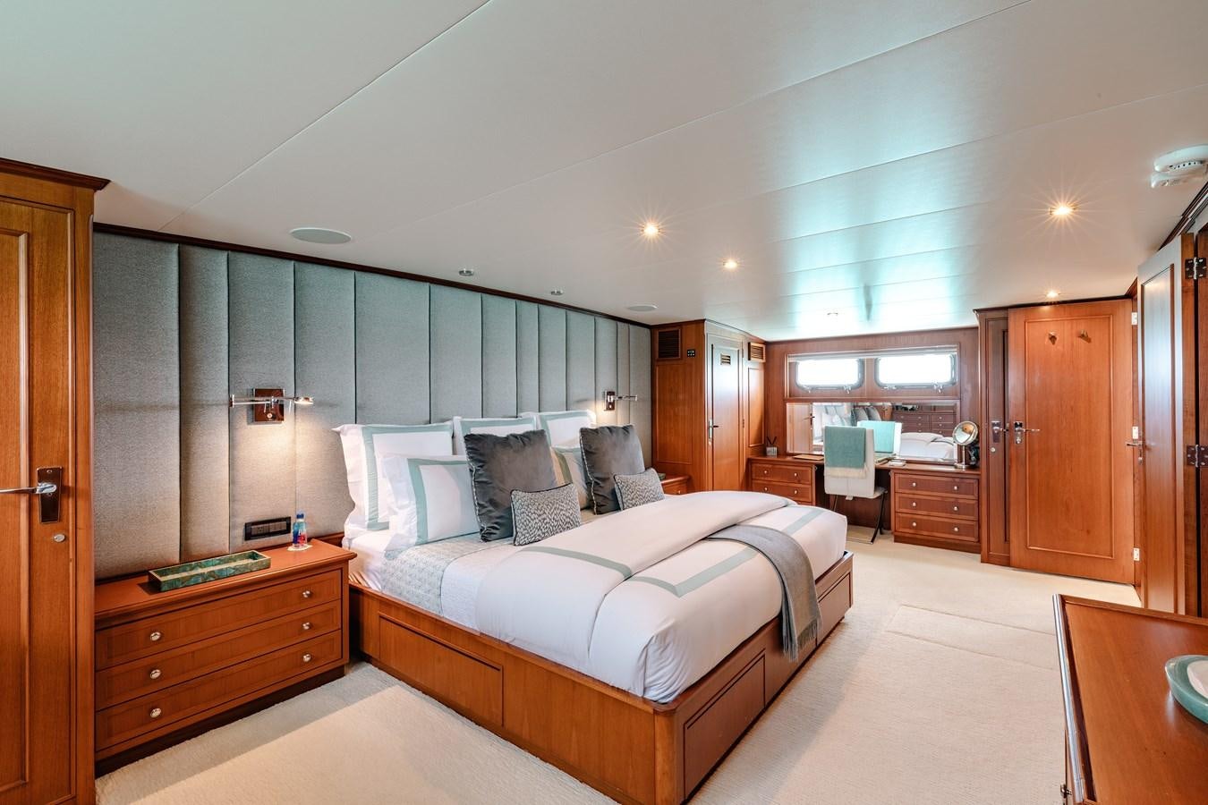a bedroom with a bed and a desk aboard CALYPSO Yacht for Sale