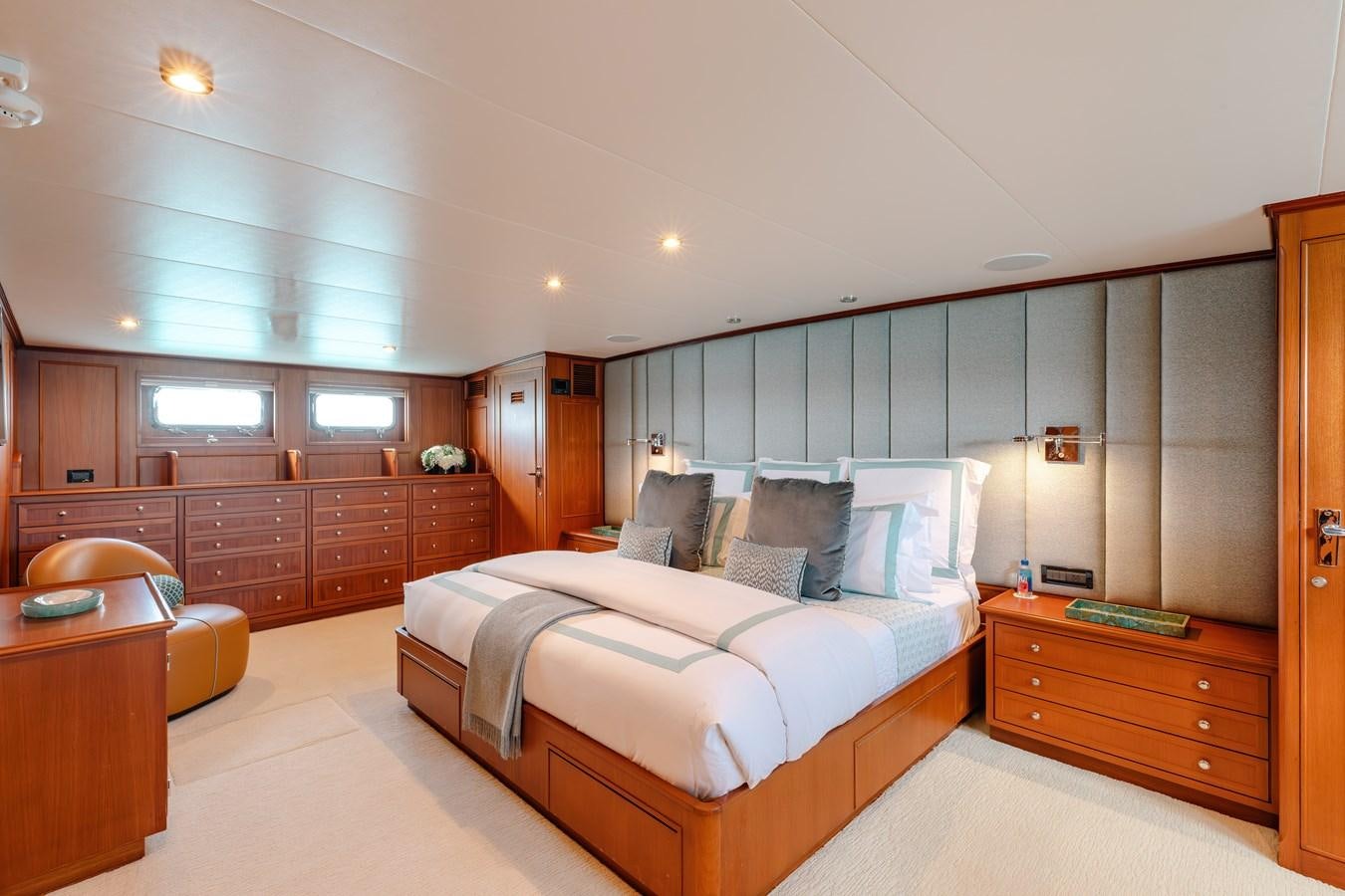 a bedroom with a bed and a desk aboard CALYPSO Yacht for Sale