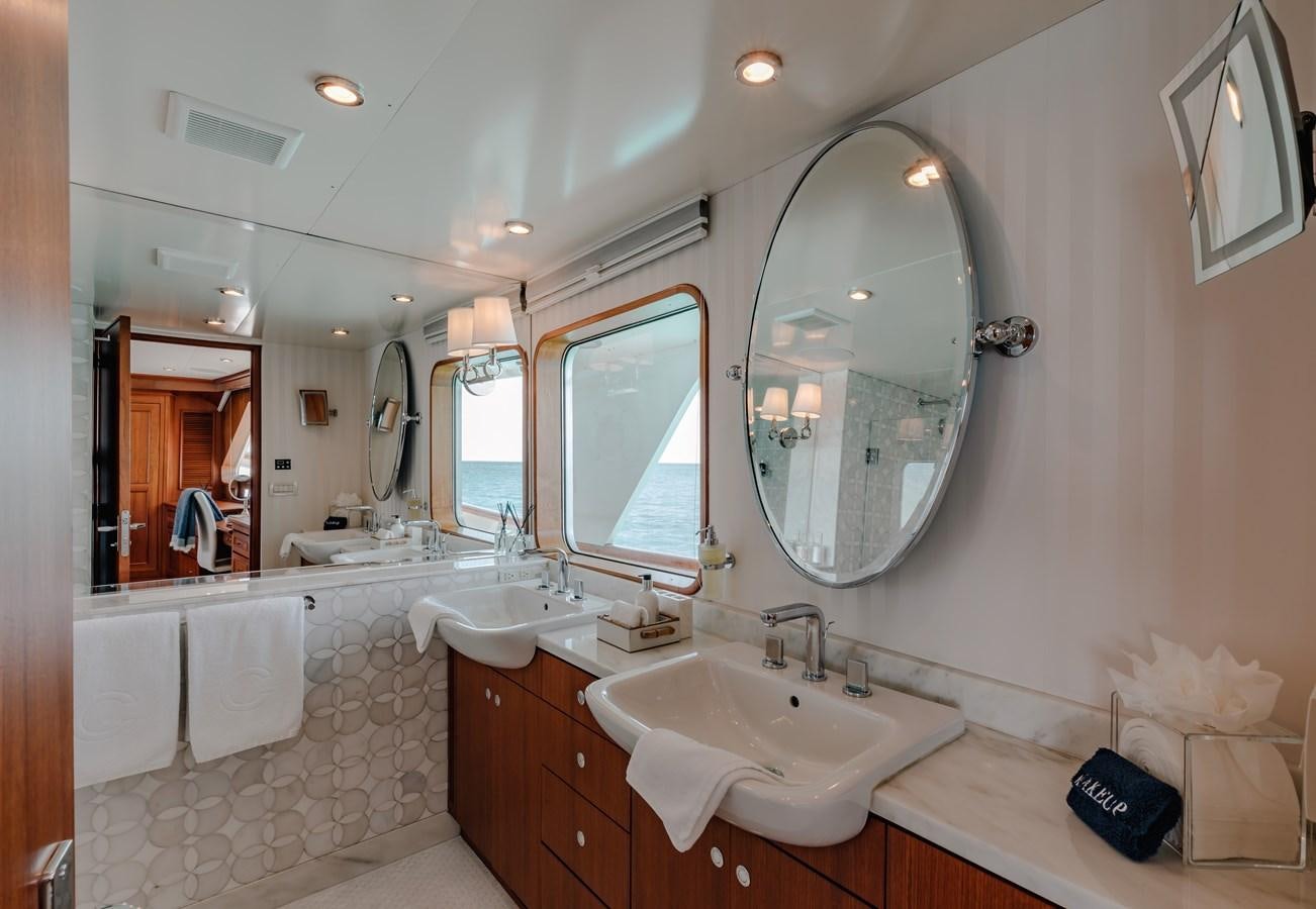 a bathroom with a large mirror aboard CALYPSO Yacht for Sale