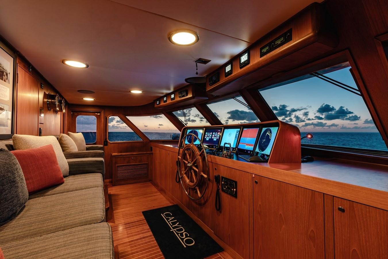 a room with a couch and a tv on the wall aboard CALYPSO Yacht for Sale