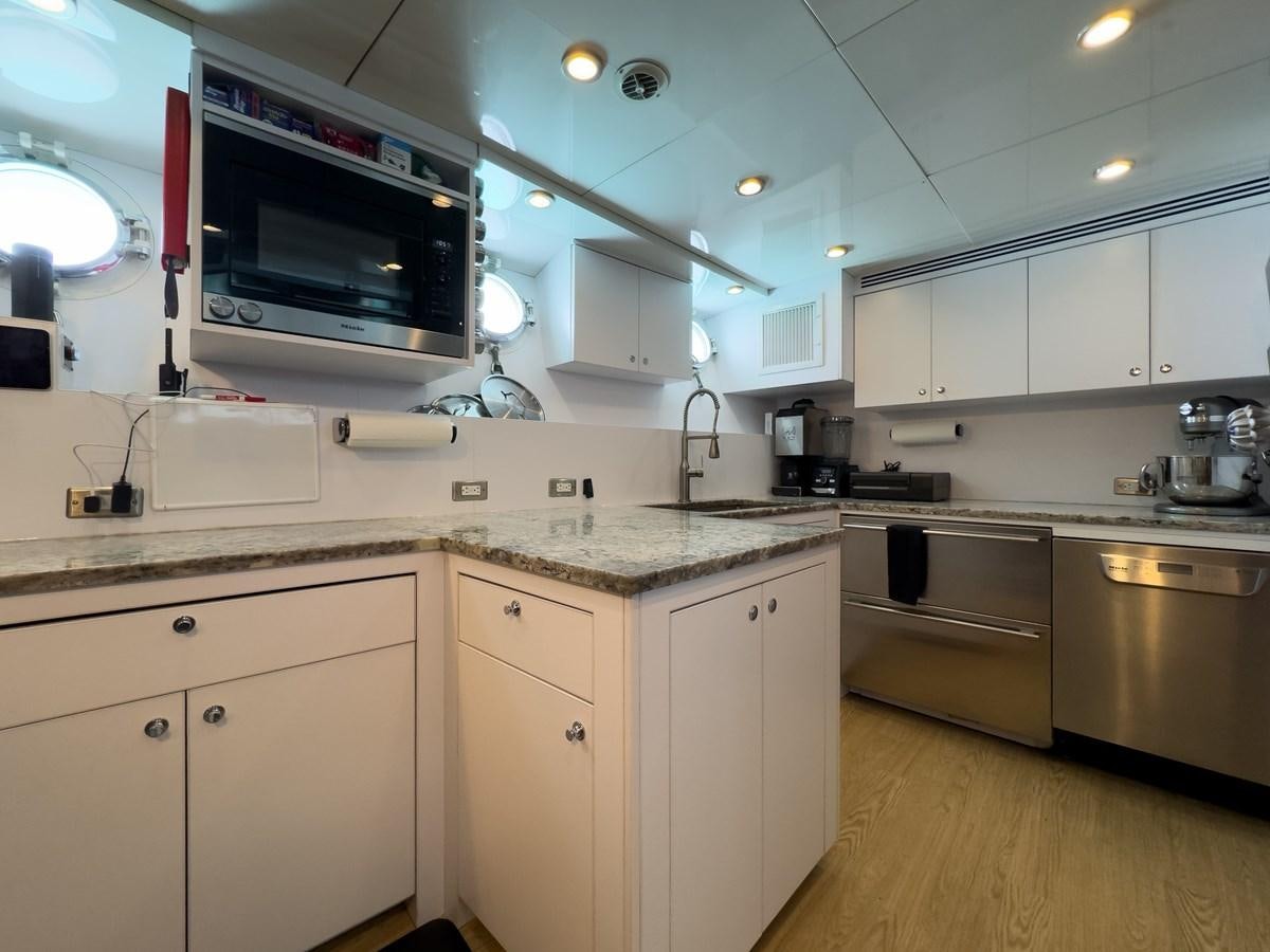 a kitchen with white cabinets aboard CALYPSO Yacht for Sale