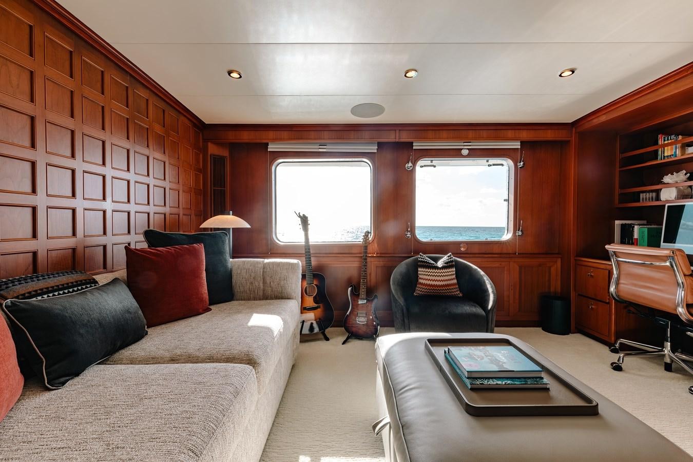 a living room with a couch and a coffee table aboard CALYPSO Yacht for Sale