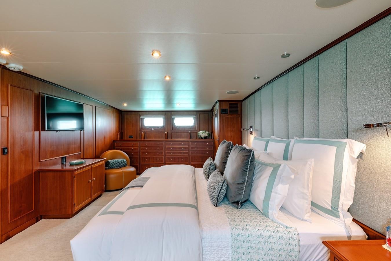 a bedroom with a bed and a desk aboard CALYPSO Yacht for Sale