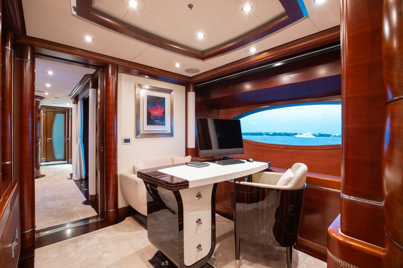 a room with a desk and a large window aboard LADY B Yacht for Sale
