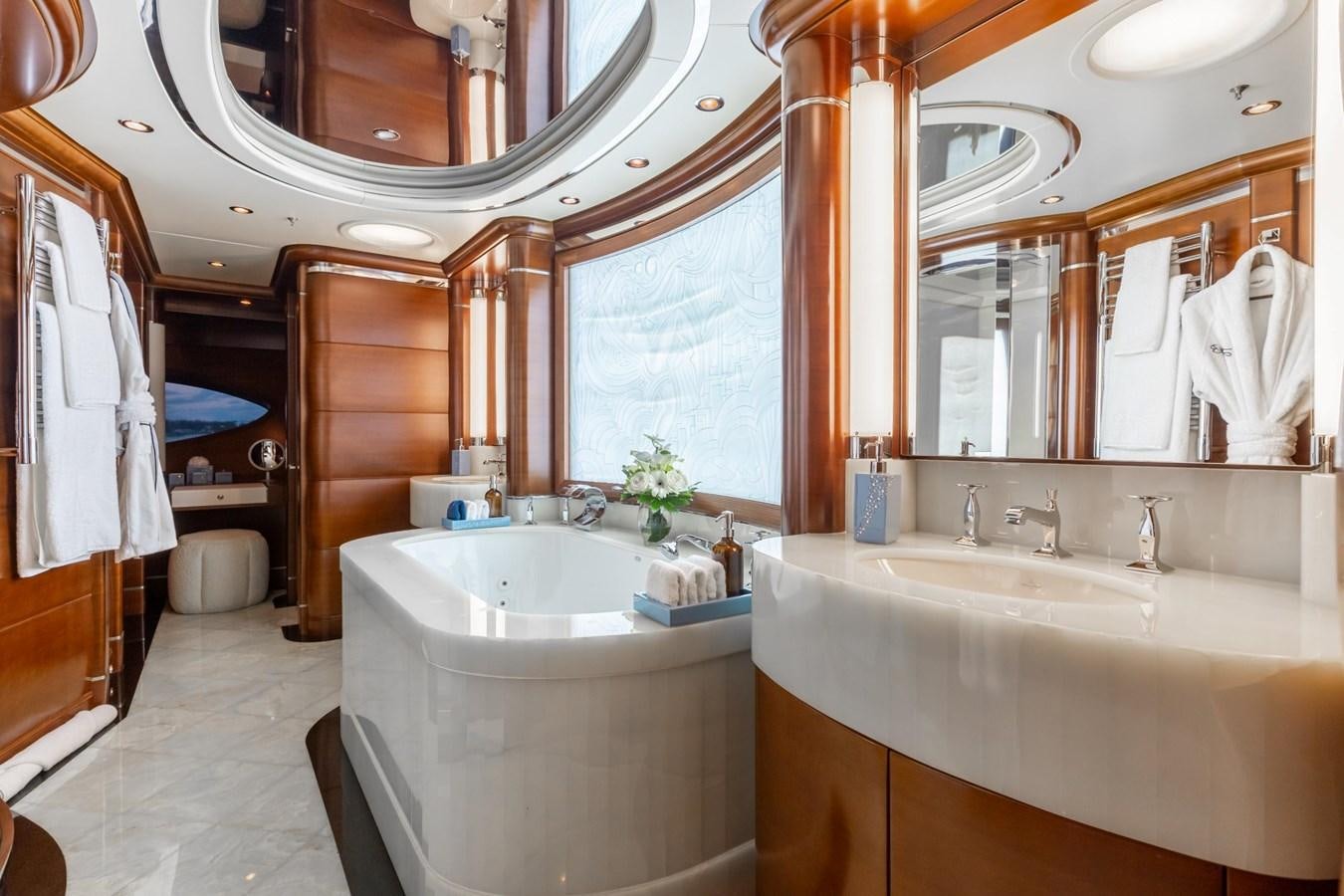 a bathroom with a tub sink and a mirror aboard LADY B Yacht for Sale