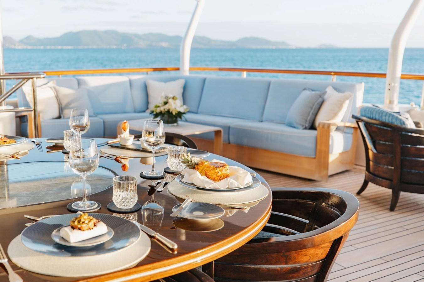 a table with plates and food on it aboard LADY B Yacht for Sale