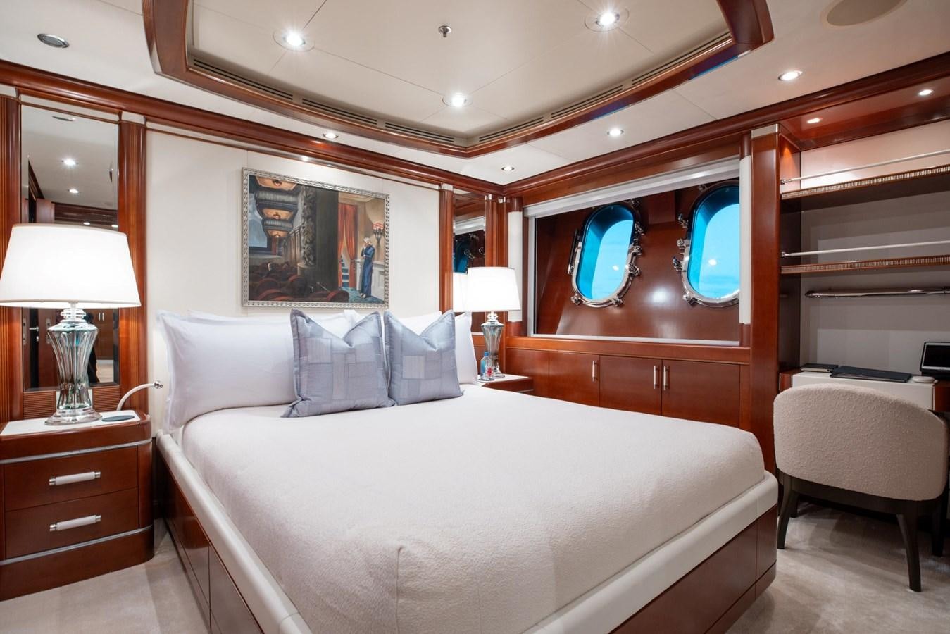 a bed with a white bed spread aboard LADY B Yacht for Sale