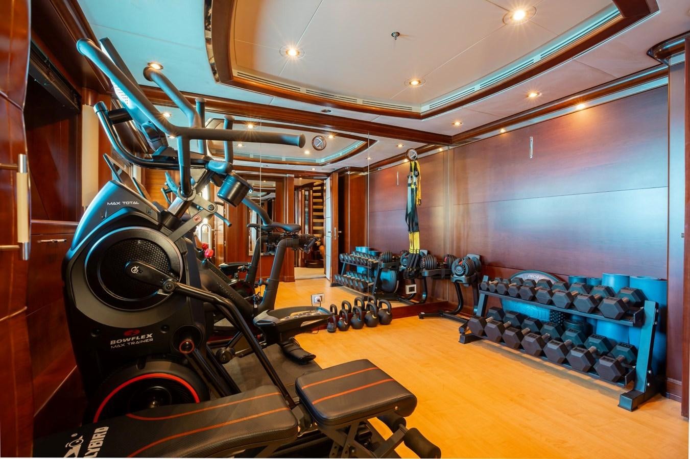 a large gym with equipment aboard LADY B Yacht for Sale