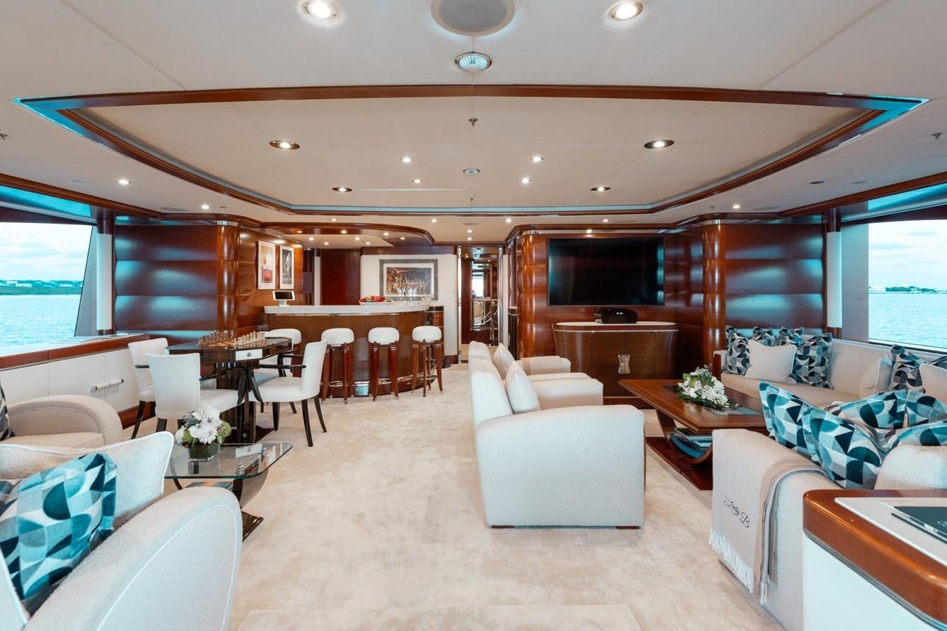 a living room with a couch and a table aboard LADY B Yacht for Sale