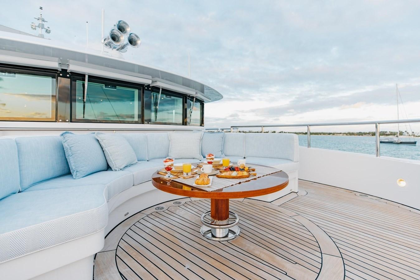 a living room with a couch and a table aboard LADY B Yacht for Sale