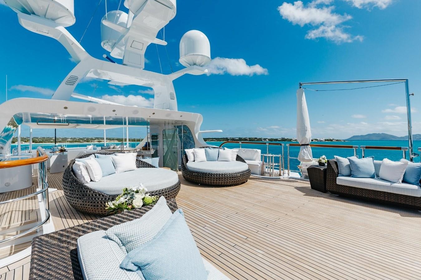 a room with a table and chairs and a large body of water aboard LADY B Yacht for Sale